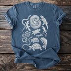 Blue t-shirt with white graphic of various reptiles including snakes and turtles.