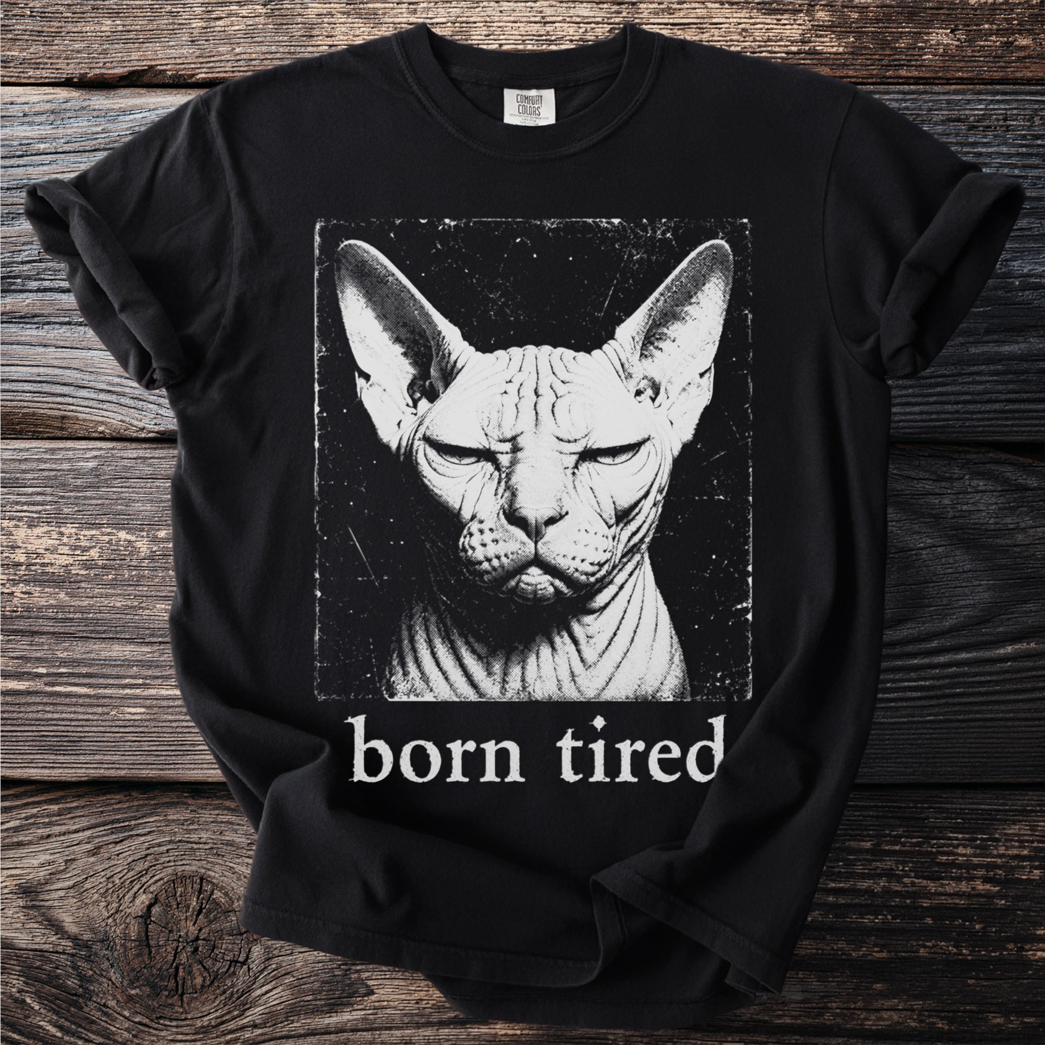 Black t-shirt with a close-up, distressed graphic of a Sphynx cat and the text "born tired".