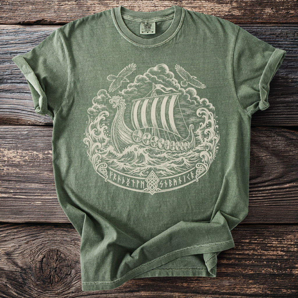 Green t-shirt with white Viking ship, stormy seas, two birds, and runes design.