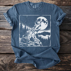 Frog croaking under a full moon with trees and mountains on a t-shirt.