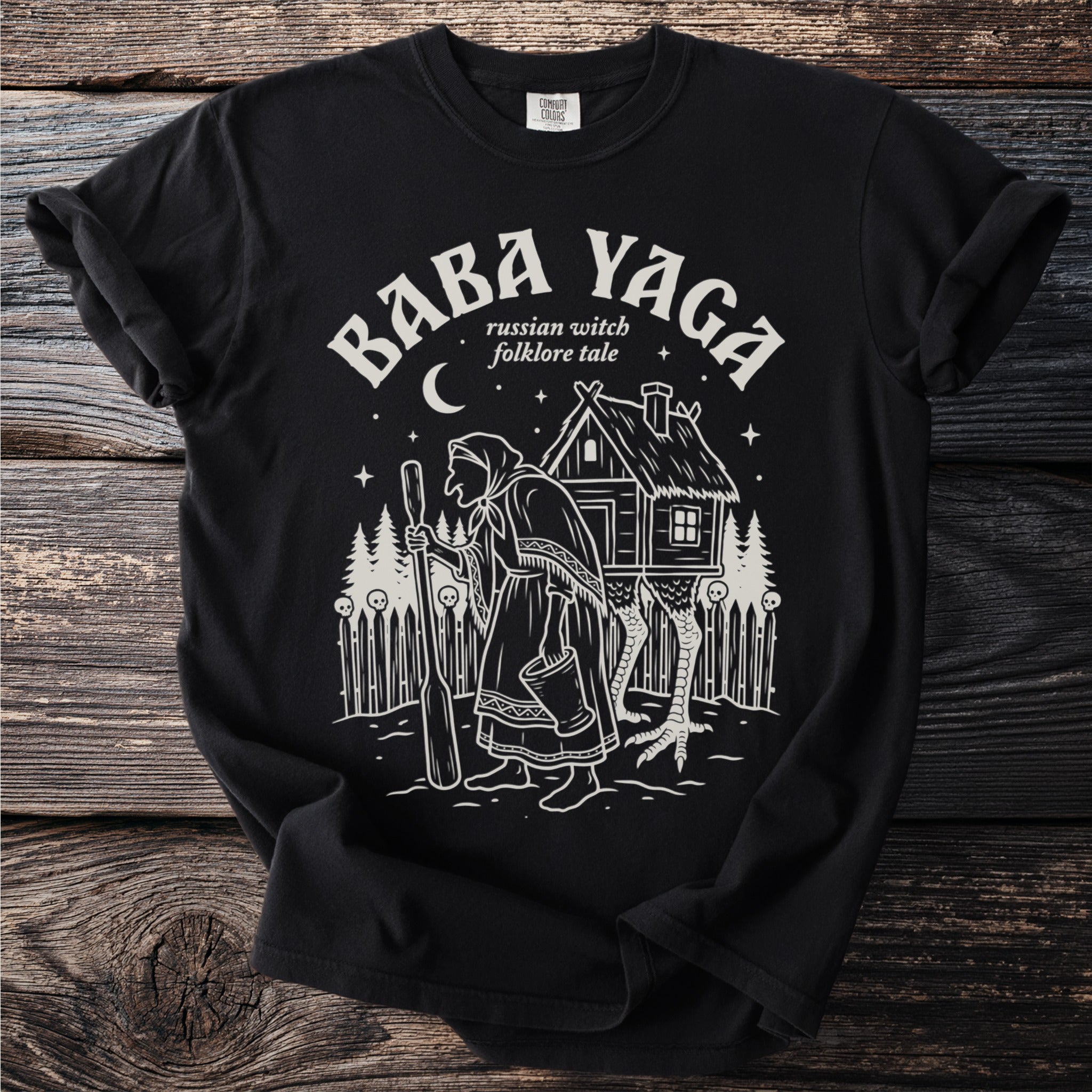 Black t-shirt with Baba Yaga folklore graphic.