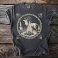 Dark t-shirt with a beige graphic of a deer by a campfire within a wreath.