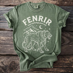 Green t-shirt with Fenrir, norse mythology giant wolf, design and mountains.
