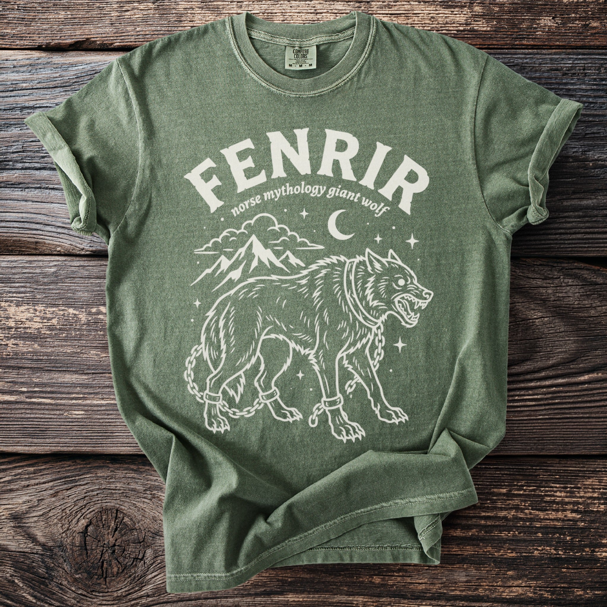 Green t-shirt with Fenrir, norse mythology giant wolf, design and mountains.