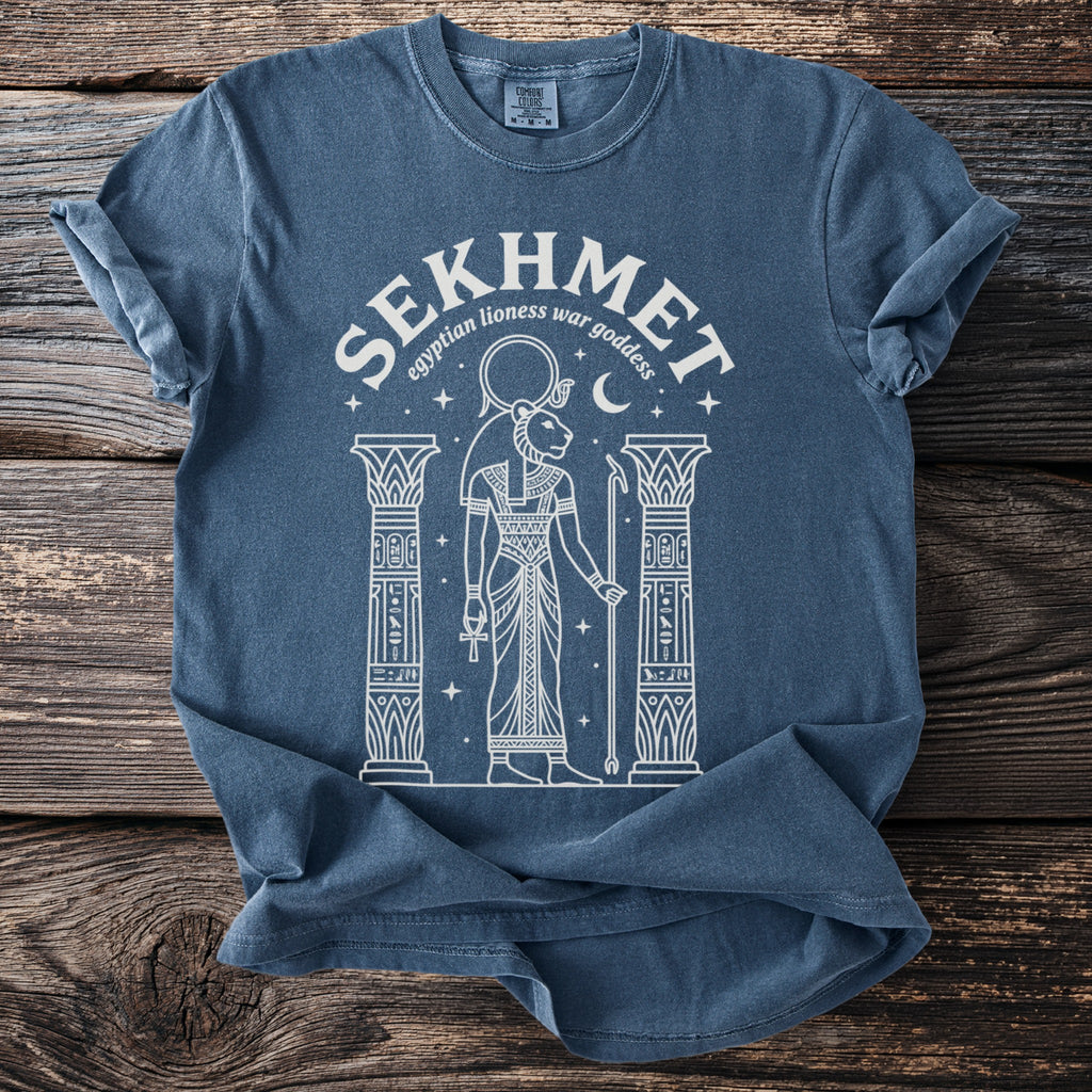 Blue t-shirt with white graphic of Sekhmet, Egyptian lioness war goddess.