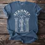 Blue t-shirt with white graphic of Sekhmet, Egyptian lioness war goddess.