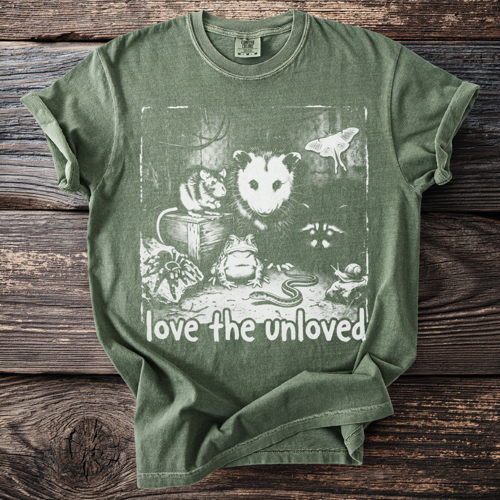 Green t-shirt with white graphic of possum, mouse, frog, snake, spider, snail, moth, and raccoon.