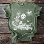 Green t-shirt with white graphic of possum, mouse, frog, snake, spider, snail, moth, and raccoon.