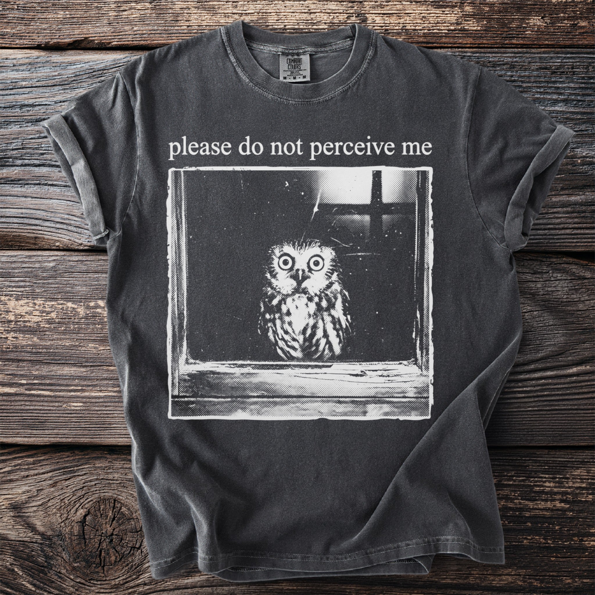 Dark gray t-shirt with text "please do not perceive me" and an owl graphic.