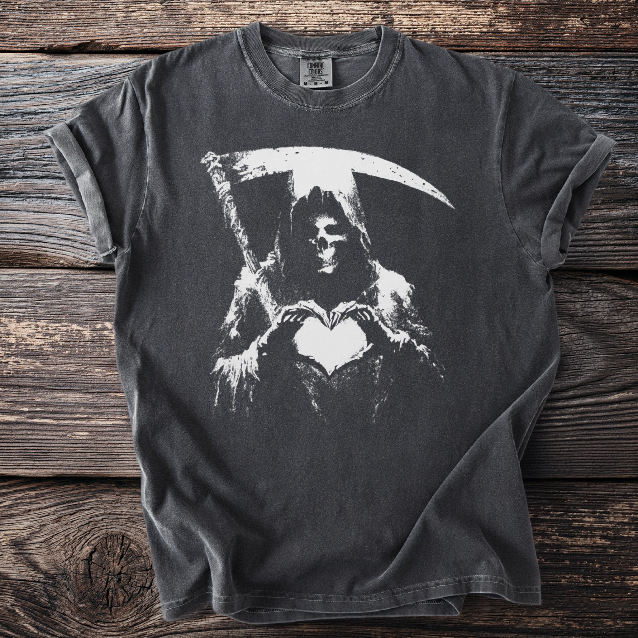 Grim reaper in a hooded robe holds a heart shape with its hands.
