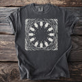Dark grey t-shirt with a circular graphic of hooded figures and stars.
