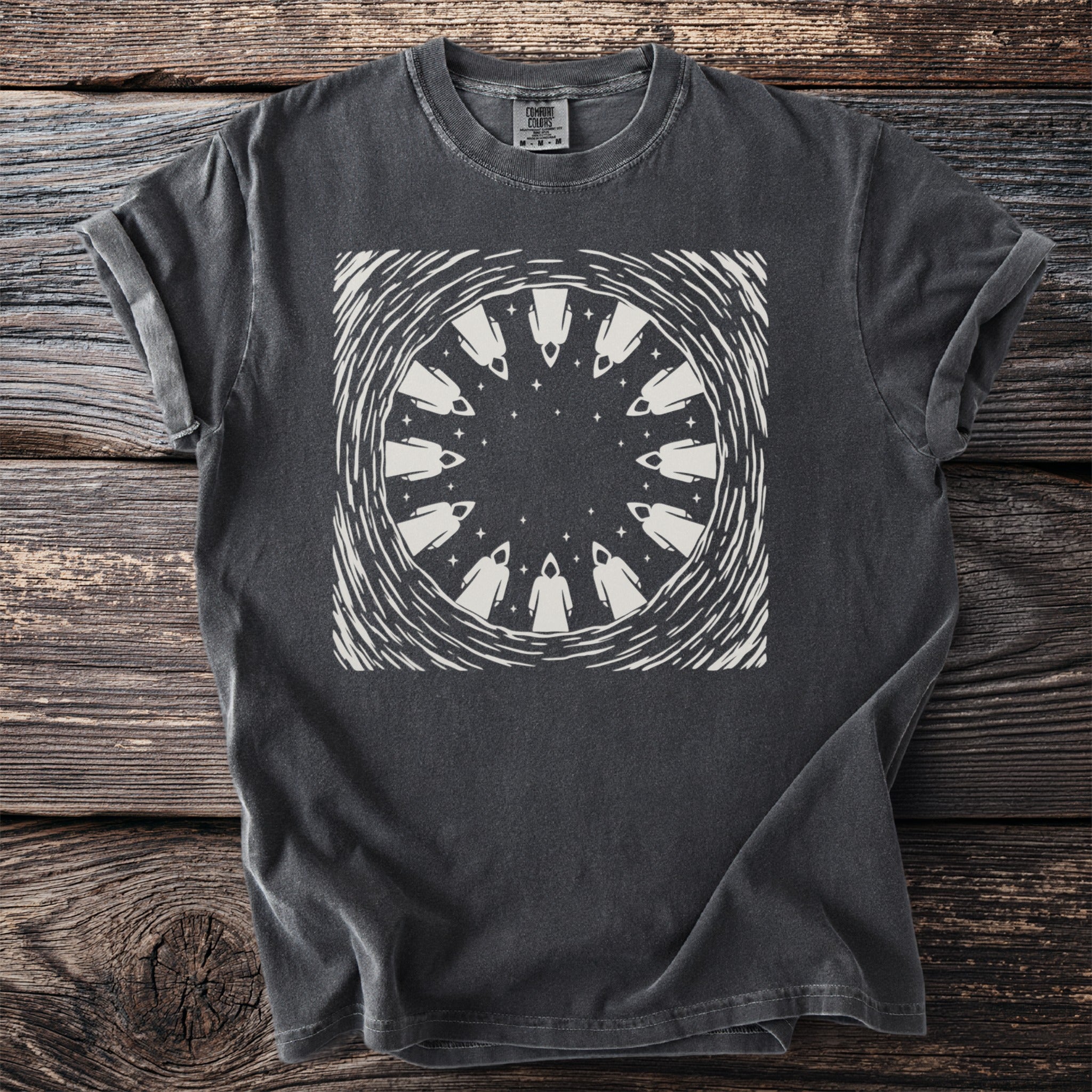 Dark grey t-shirt with a circular graphic of hooded figures and stars.