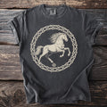 Dark t-shirt with a light-colored graphic of a horse inside a thorny circle.
