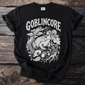 Black t-shirt with white "Goblincore" text and forest illustration of toad, snail, and skull.