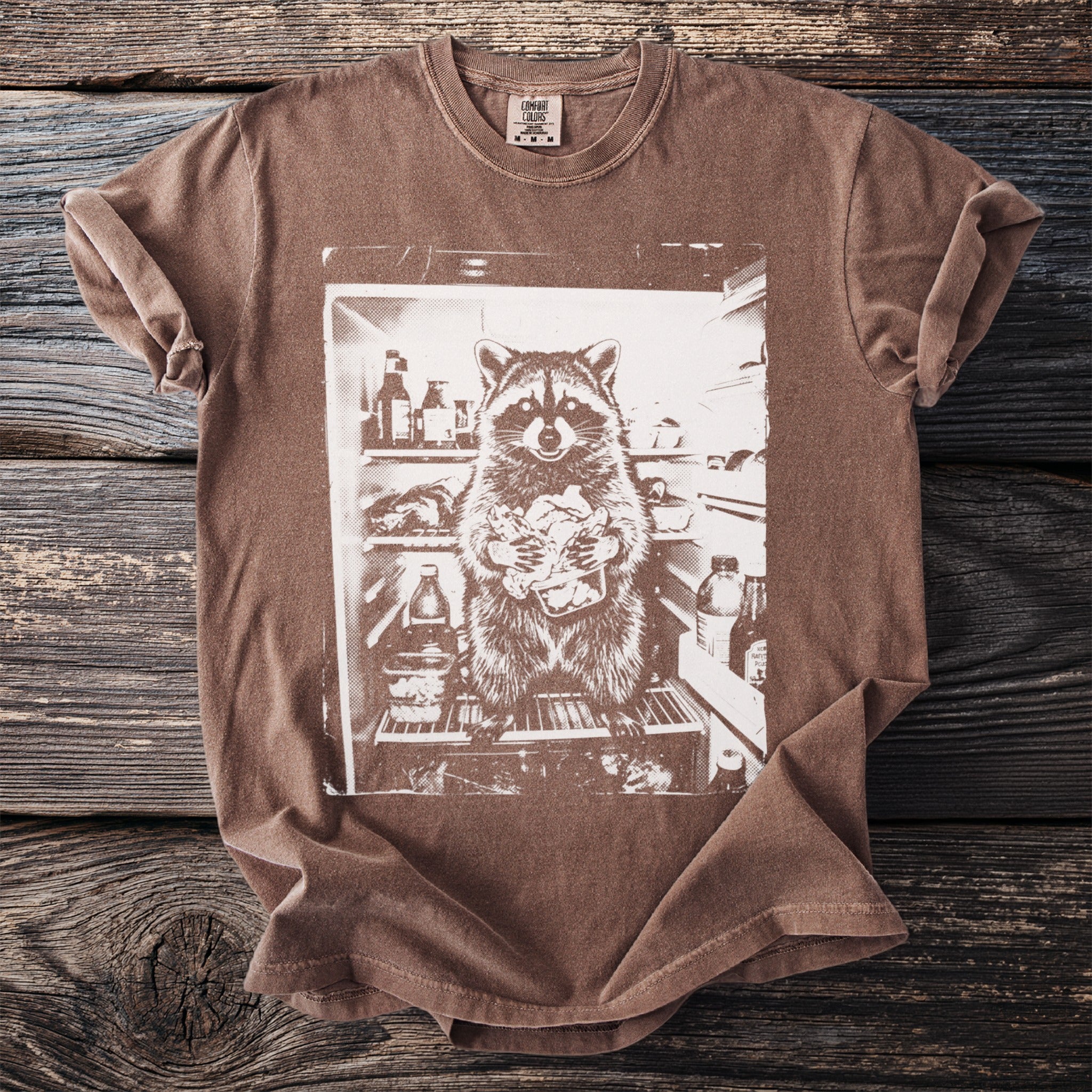 Brown t-shirt with a washed-out print of a raccoon raiding a refrigerator.