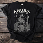 Black t-shirt with white line art of Anubis, Egyptian mythology jackal god, and pyramids.