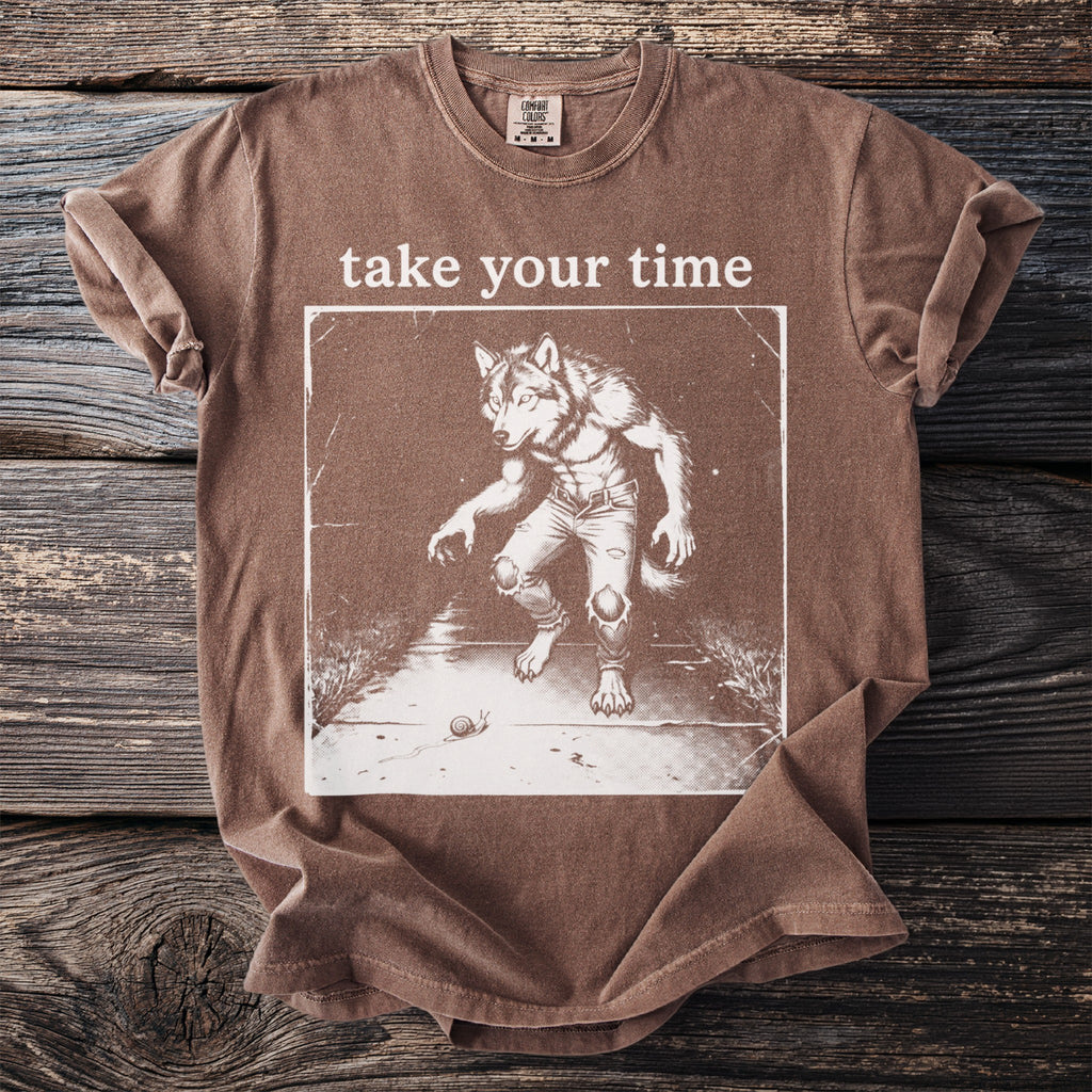 Brown t-shirt with "take your time" text and a werewolf graphic with a snail.