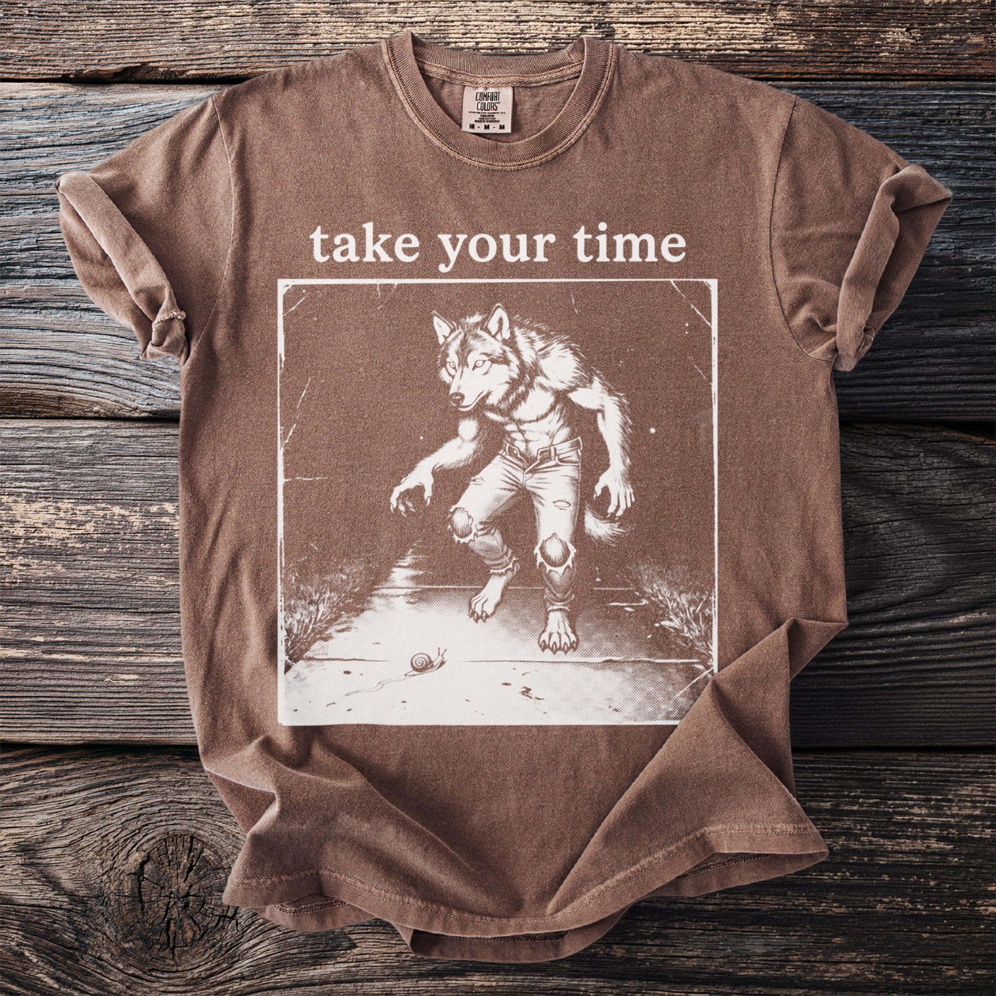 Brown t-shirt with "take your time" text and a werewolf graphic with a snail.