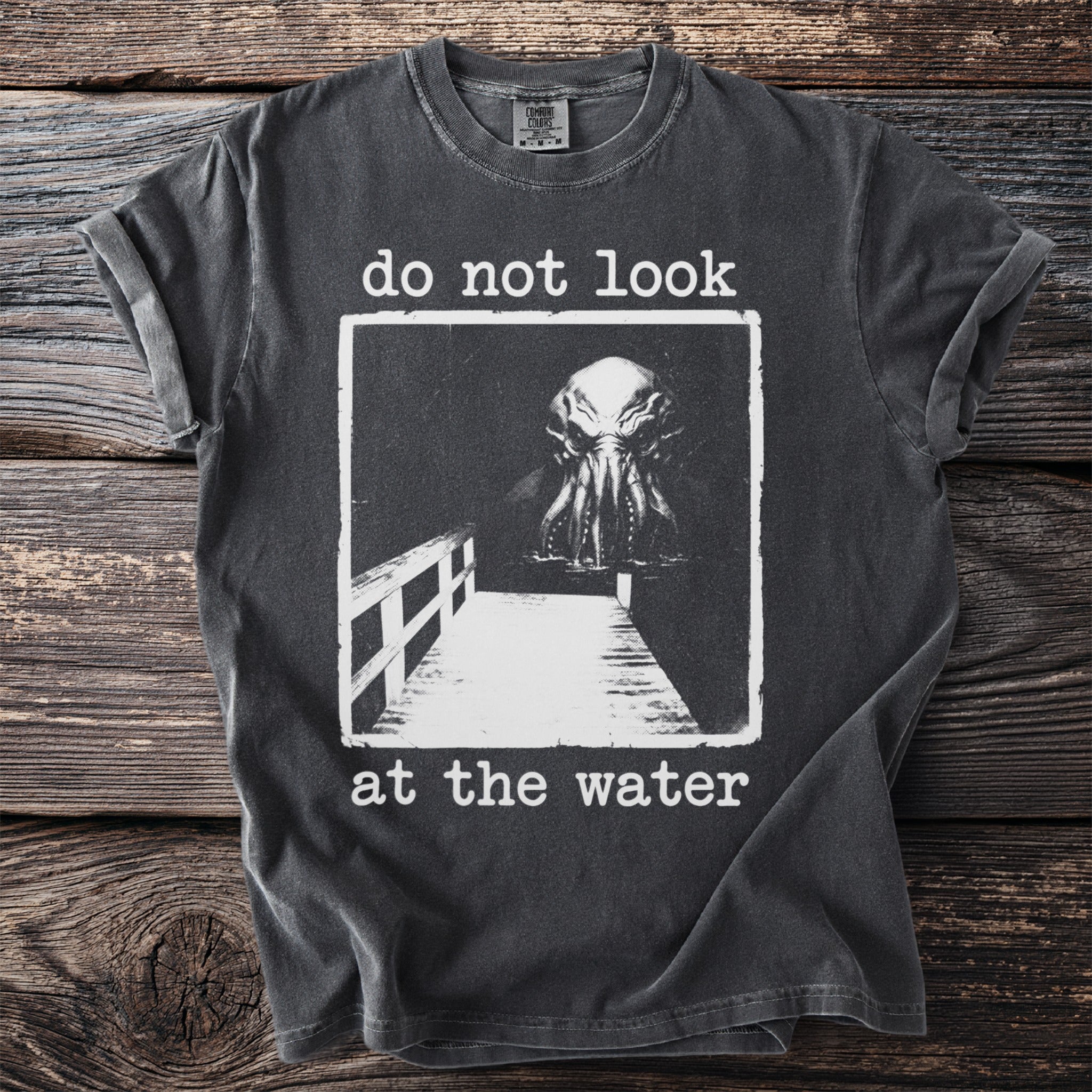Dark grey t-shirt with tentacled creature and text "do not look at the water".