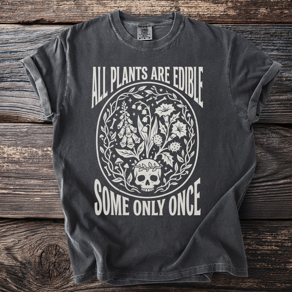 Dark t-shirt with white text "All Plants Are Edible Some Only Once" and skull and plant graphic.