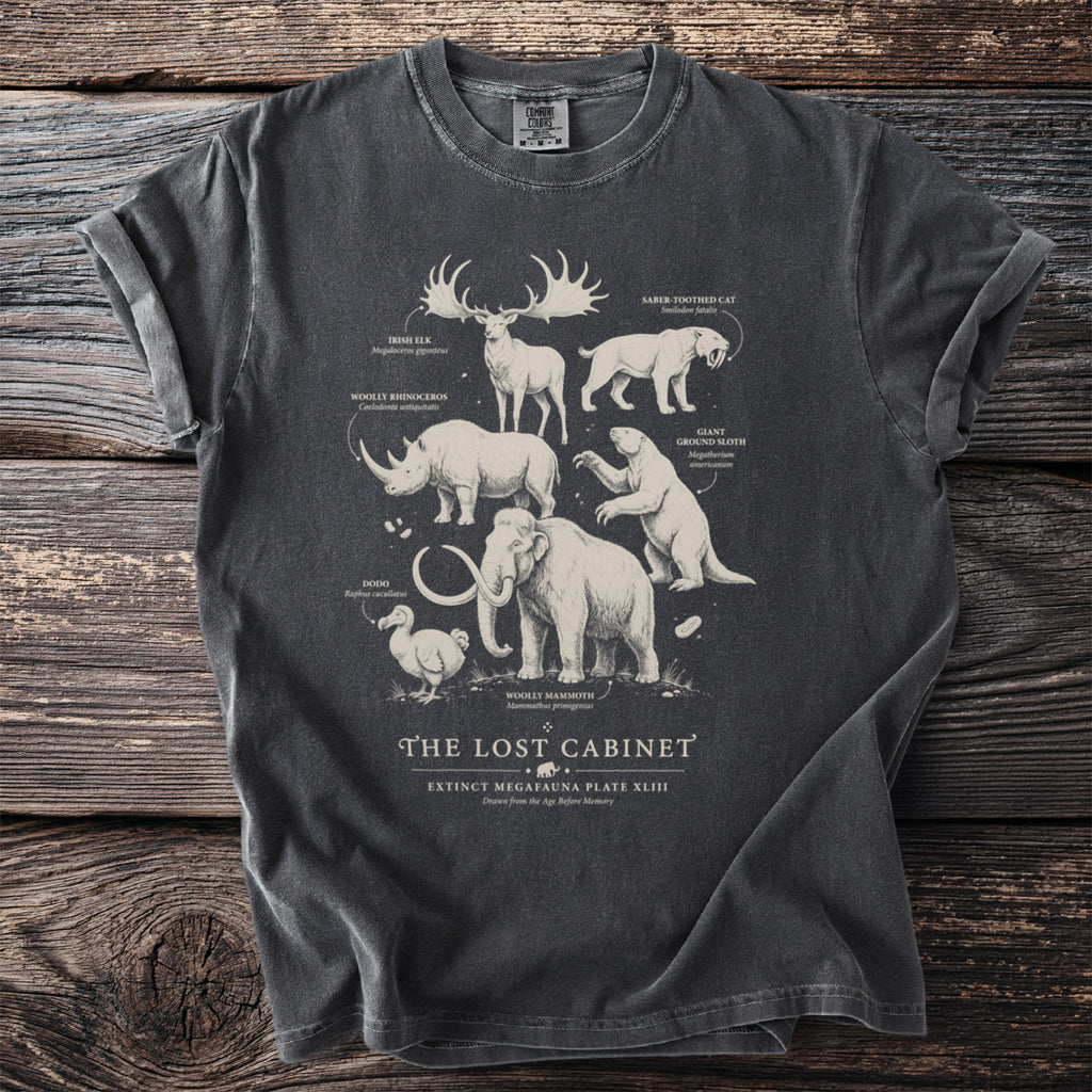 Grey t-shirt featuring extinct megafauna illustrations: Irish Elk, Woolly Rhino, Dodo, Saber-toothed Cat, Giant Ground Sloth, Woolly Mammoth.