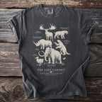 Grey t-shirt featuring extinct megafauna illustrations: Irish Elk, Woolly Rhino, Dodo, Saber-toothed Cat, Giant Ground Sloth, Woolly Mammoth.