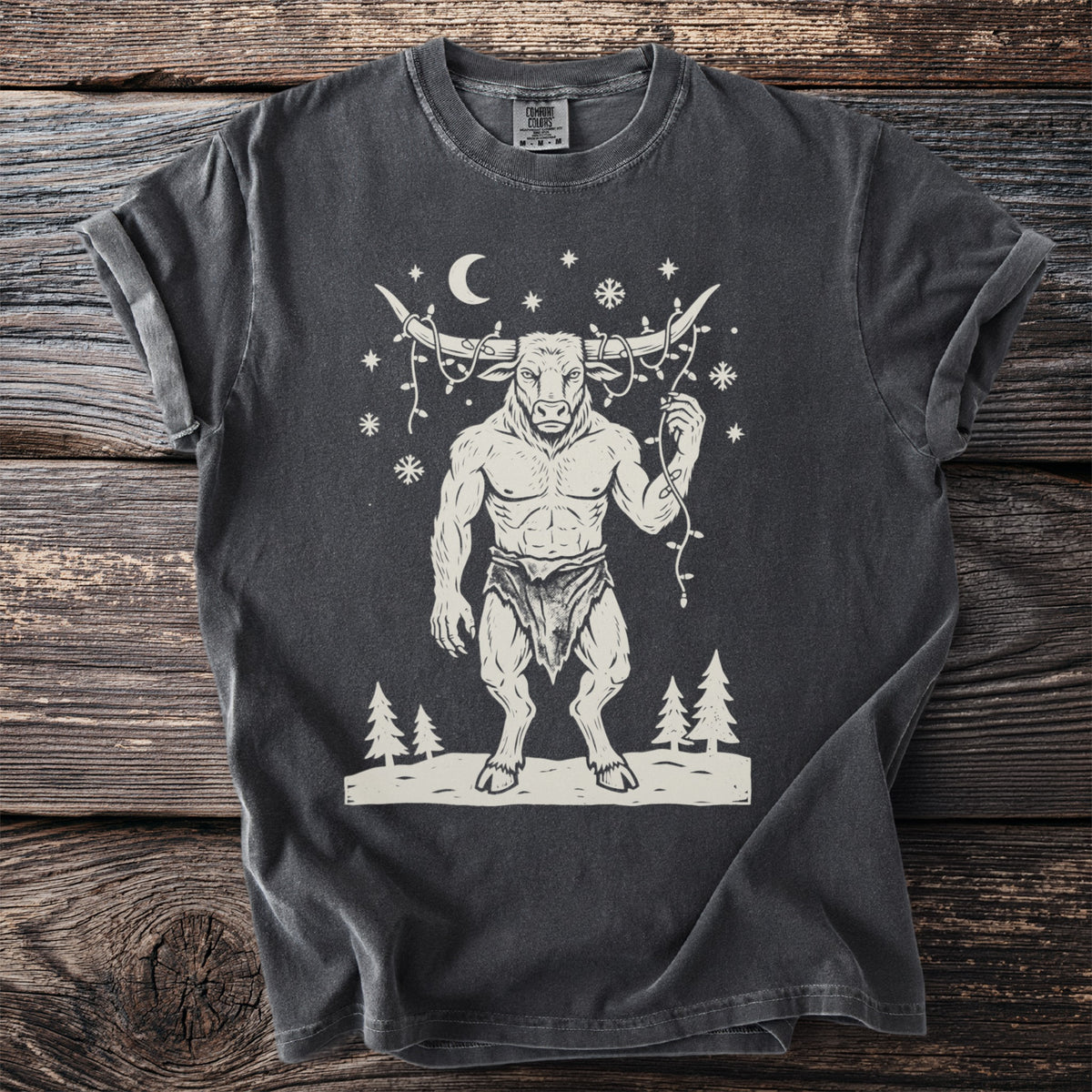 Pepper gray t-shirt with a cream folk-cut print: the Minotaur stands in the snow with a string of Christmas lights tangled around his horns.