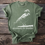 Green t-shirt with white raven graphic and "accessory to murder" text.