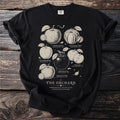 Black t-shirt with an illustration of heirloom apples titled "The Orchard".