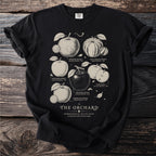 Black t-shirt with an illustration of heirloom apples titled "The Orchard".