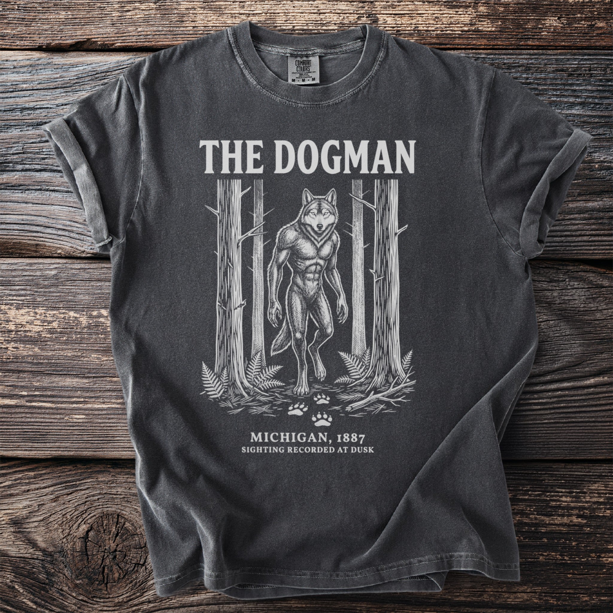 Dark gray t-shirt with "The Dogman" graphic of a werewolf in a forest.