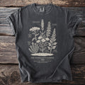 Charcoal t-shirt with an illustration of medicinal herbs and their names.