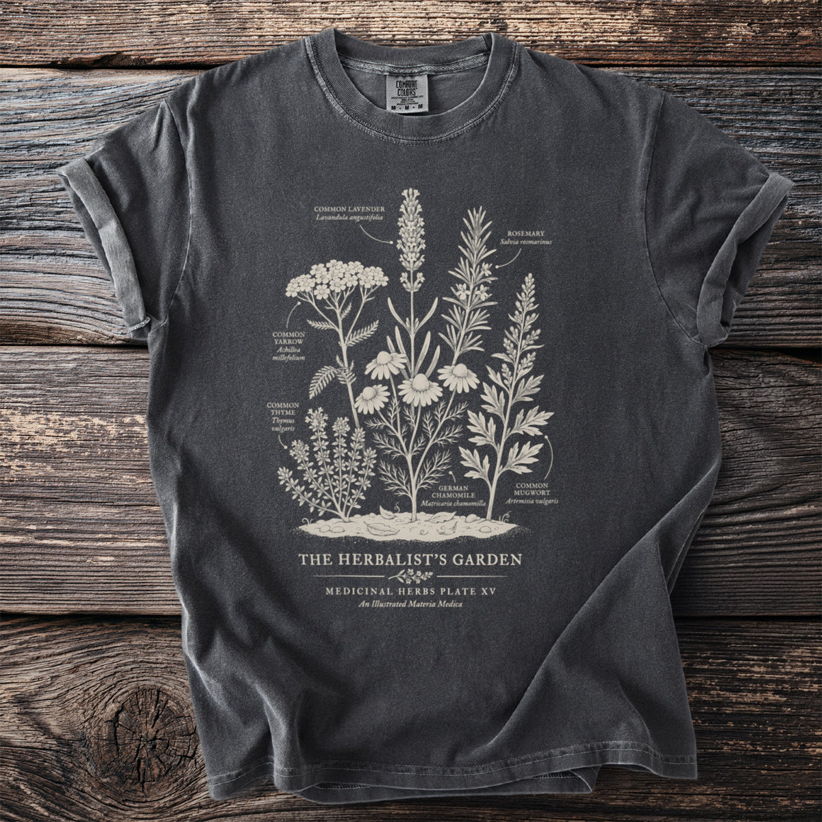 Charcoal t-shirt with an illustration of medicinal herbs and their names.