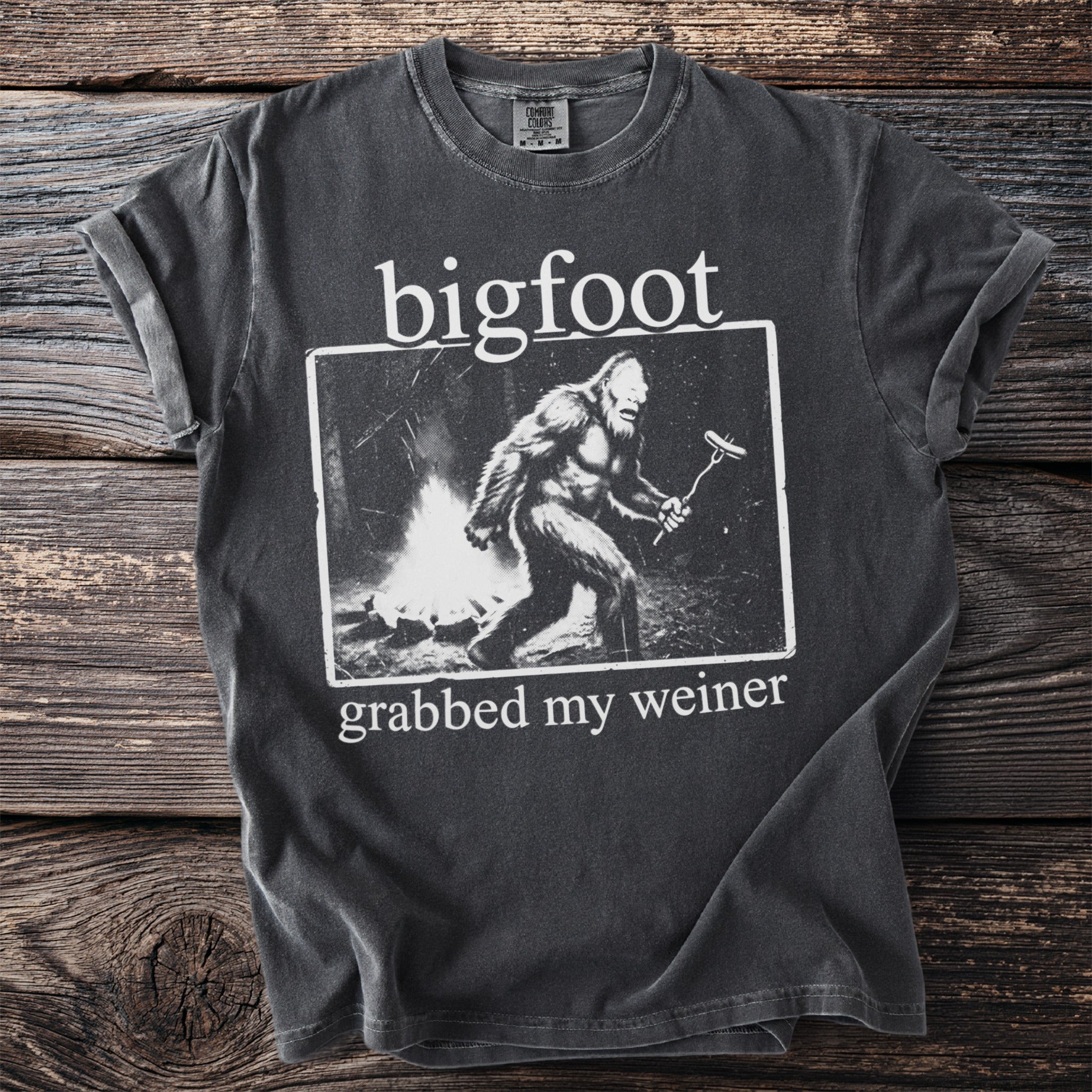 T-shirt with Bigfoot at a campfire grilling a hot dog and text "bigfoot grabbed my weiner".