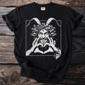 Black t-shirt with a white illustration of a grinning satyr wearing a wreath of leaves and flowers.