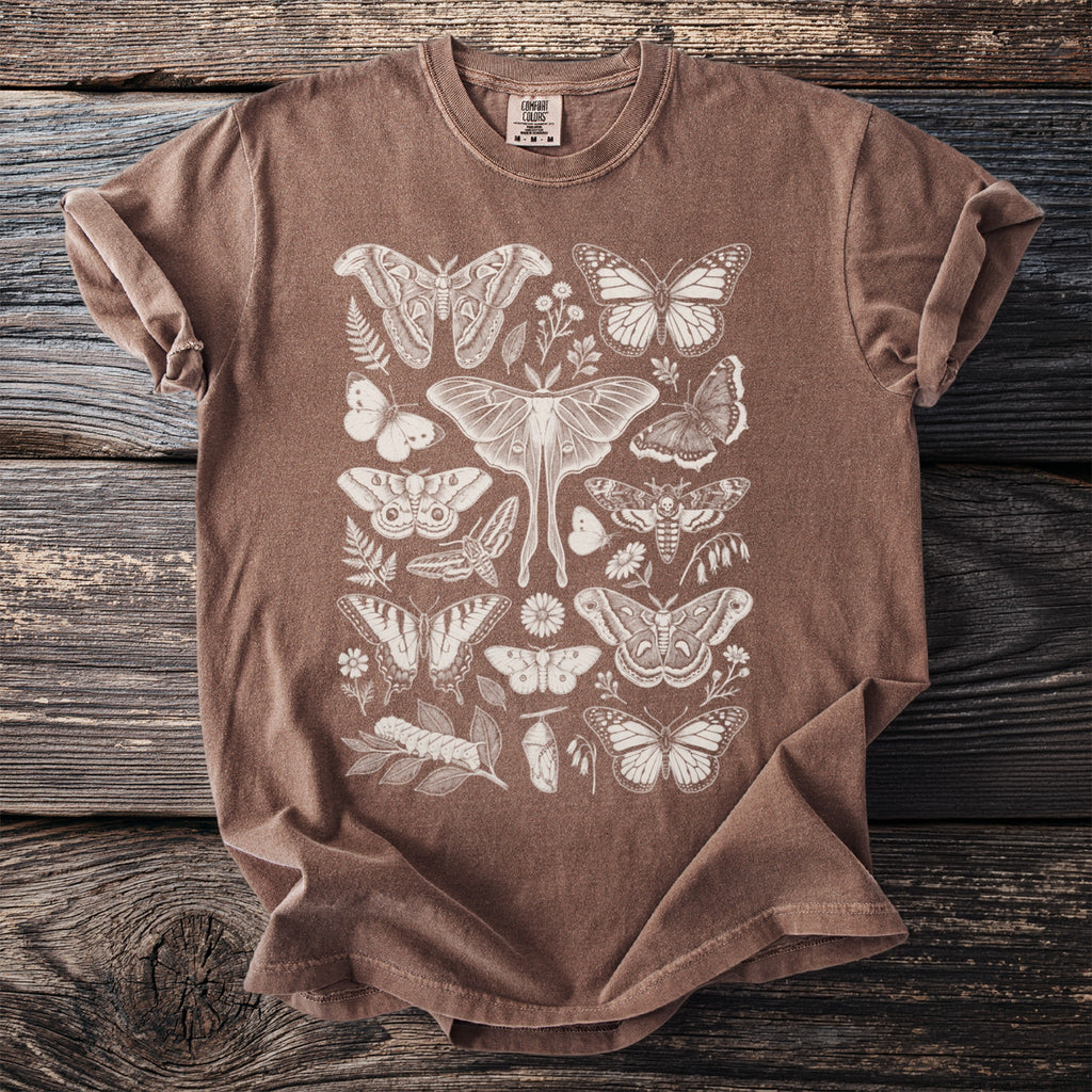 Brown t-shirt with an off-white detailed print of various moths, butterflies, leaves, and flowers.