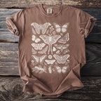 Brown t-shirt with an off-white detailed print of various moths, butterflies, leaves, and flowers.