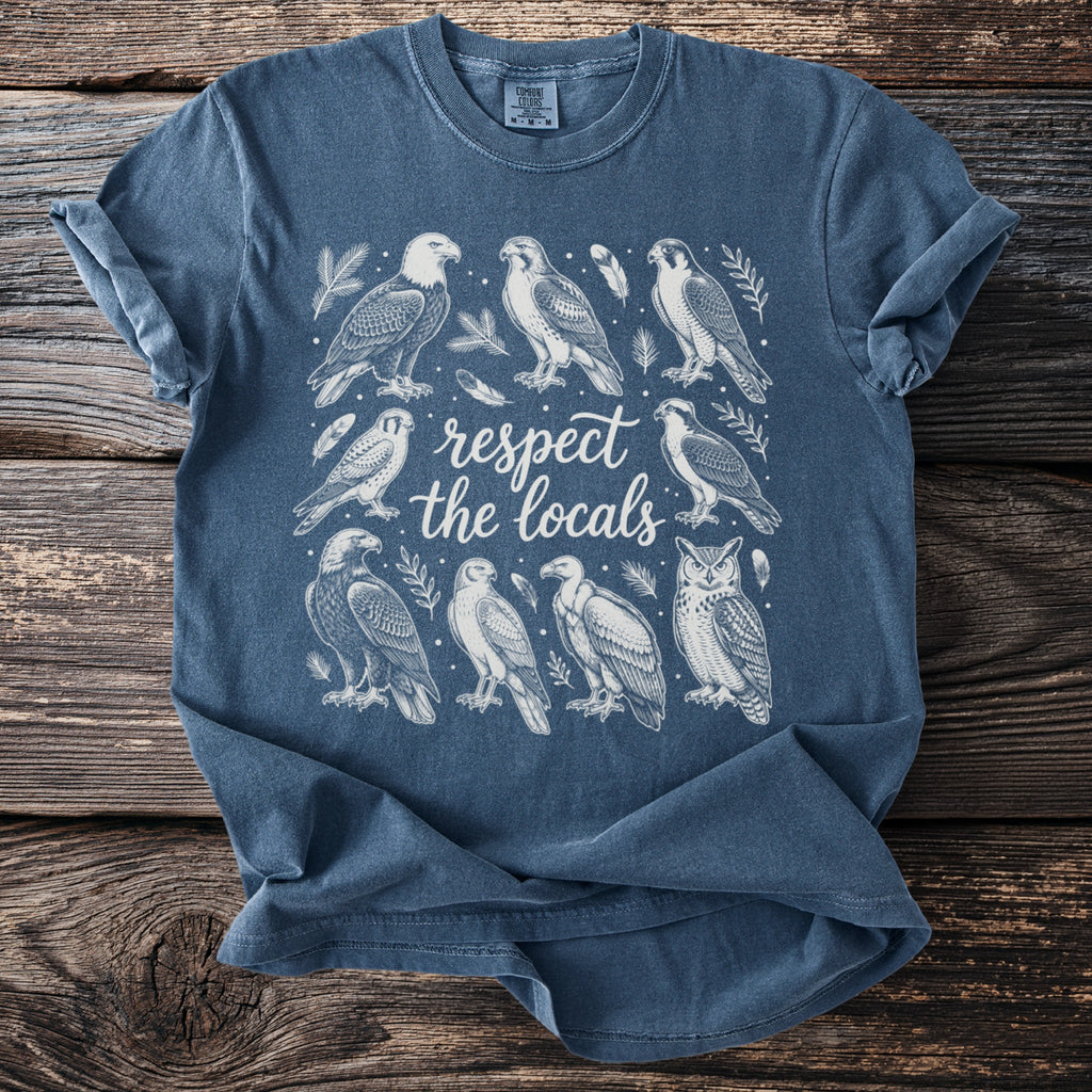 Blue t-shirt with white illustration of birds and the text "respect the locals."
