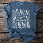 Blue t-shirt with white illustration of birds and the text "respect the locals."