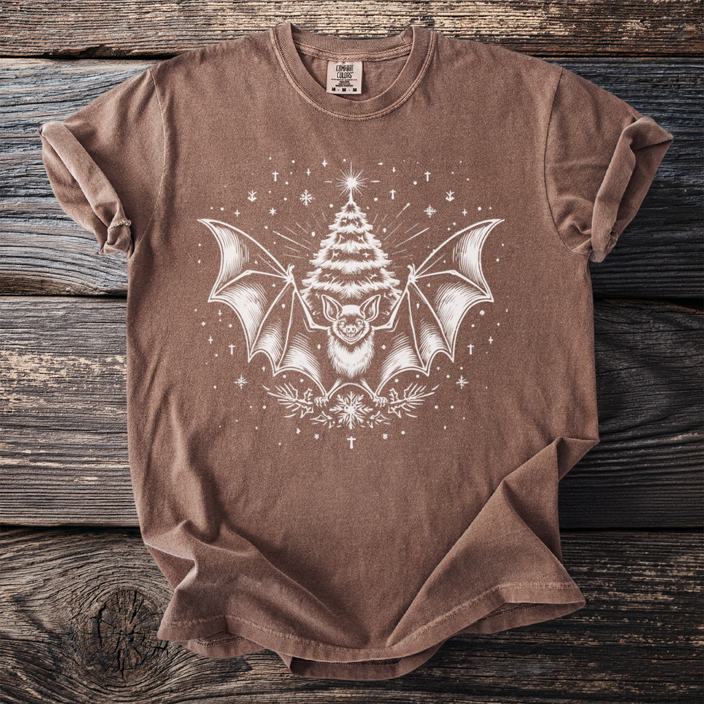Brown t-shirt with a white graphic of a bat and a Christmas tree.
