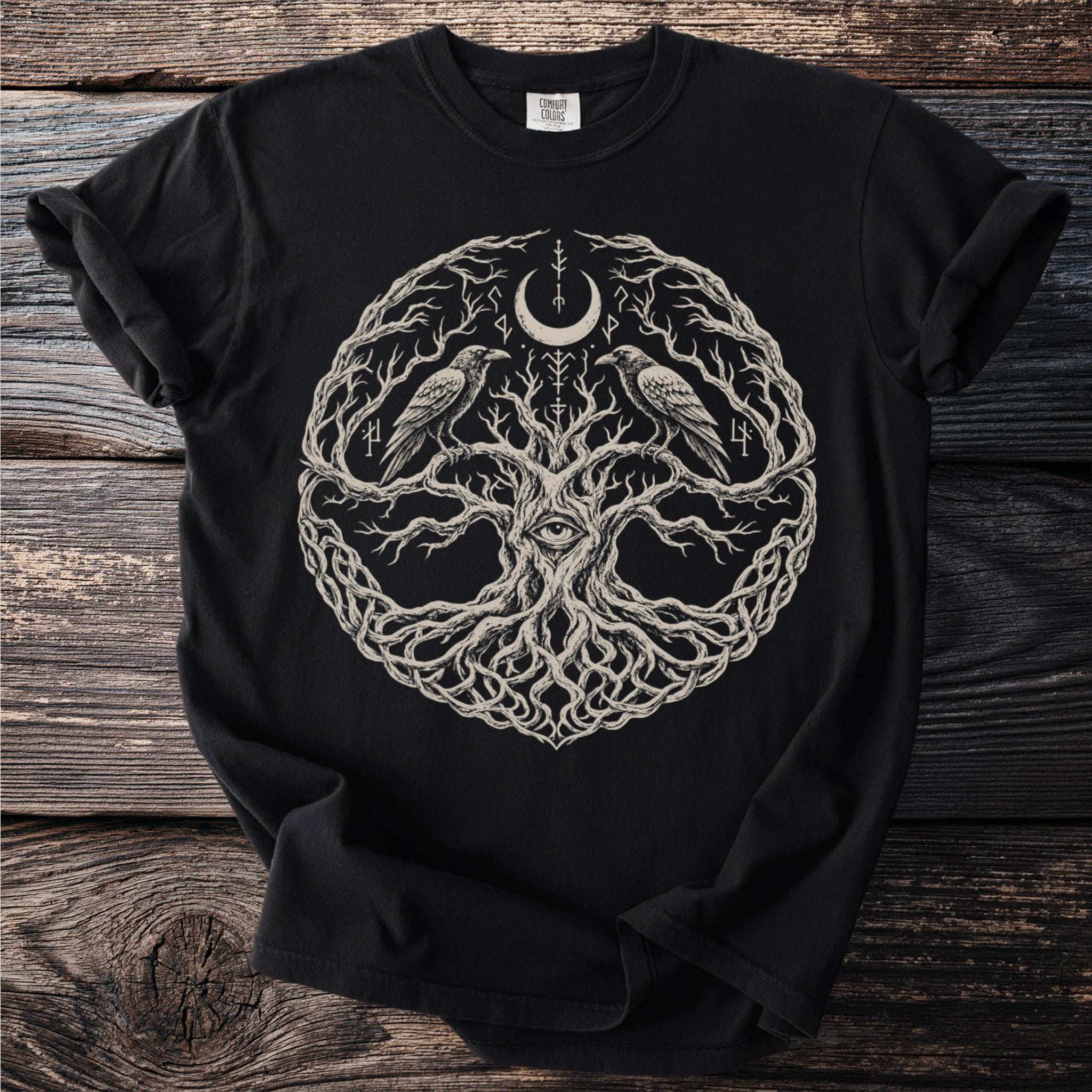 Black t-shirt featuring a circular design of a tree, ravens, eye, moon and runes.