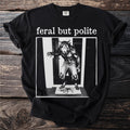 Black t-shirt with "feral but polite" and werewolf graphic.