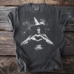 Dark grey t-shirt with white graphic of a witch making a heart shape.