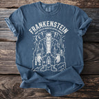 Blue t-shirt with Frankenstein's monster design and text.