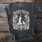 Gray t-shirt with white witch, cat, moon, stars, and botanical floral design.