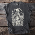Grim reaper with scythe surrounded by wheat, flowers, and birds in a field.