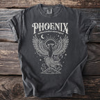 Dark grey t-shirt with white graphic of a phoenix rising from mountains, text "PHOENIX mythical firebird rebirth legend".