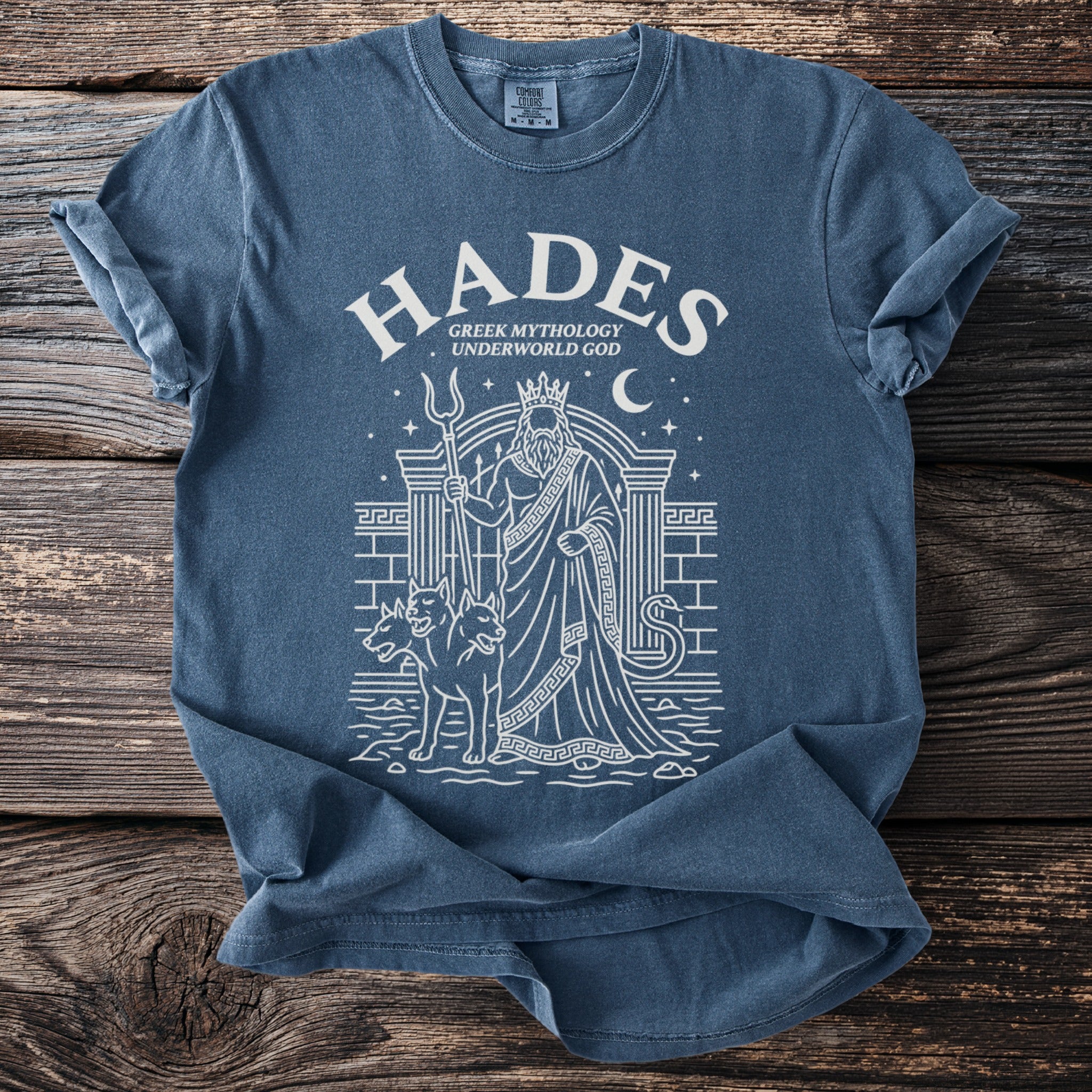 Blue t-shirt with white graphic of Hades, Cerberus, snake, and Greek architecture.