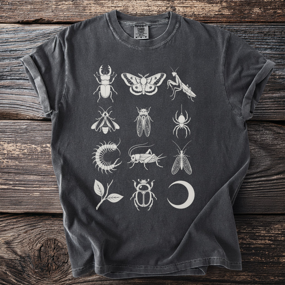 Dark grey t-shirt with a white print of various insects, a leaf, and a moon phase.