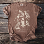 Brown t-shirt print of "The Raptor Cabinet" featuring seven birds of prey.